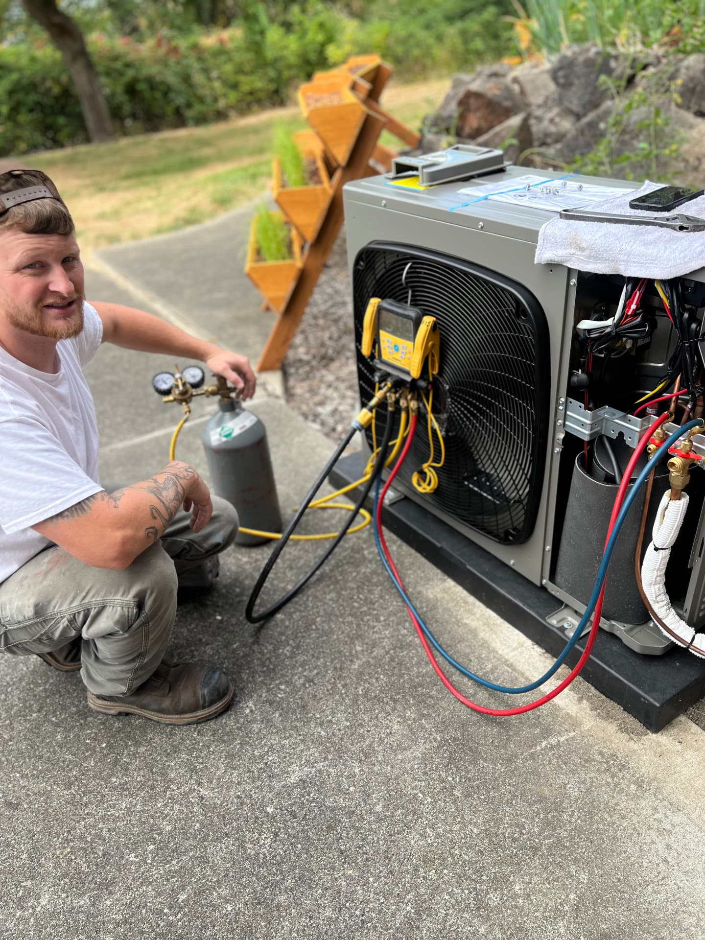 Evan, owner of The HVAC Rat, pressure-testing a newly installed heat pump with digital gauges